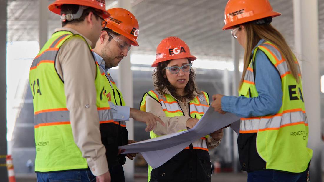 EGA project managers reviewing drawings on site